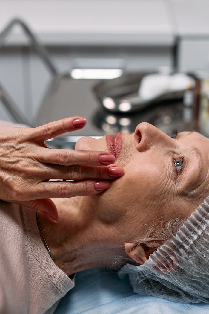 A senior woman enjoys a relaxing facial therapy session at a spa, emphasizing skincare and wellness.